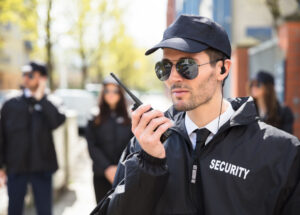 Portrait Of A Male Security Guard Talking On Walkie Talkie